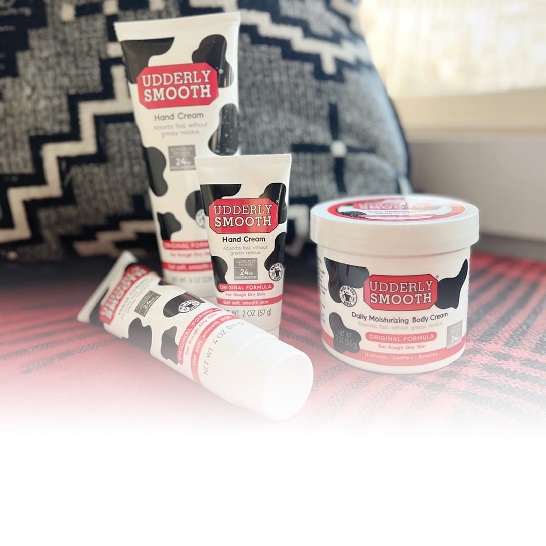 containers of Udderly Smooth laid out on a couch